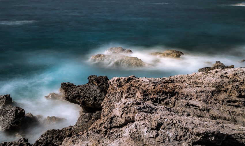 High angle view of rocks on sea shore