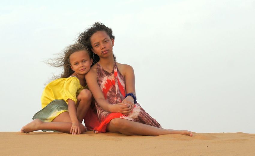 Portrait of two girls on sand