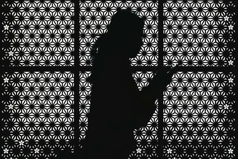 Silhouette of person standing by shadow