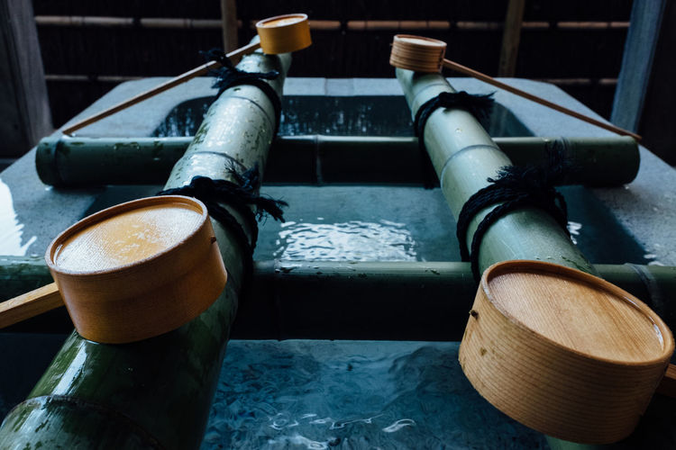 Close-up of wooden ladles at trough