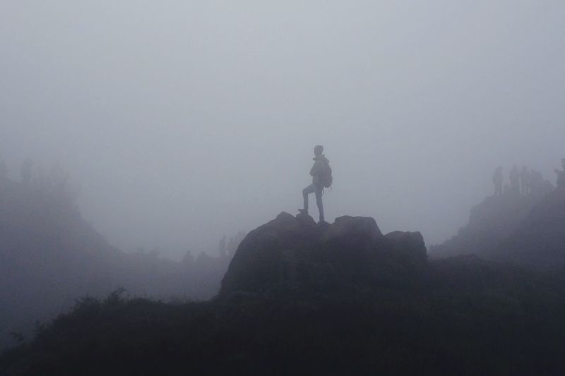 People standing in foggy weather