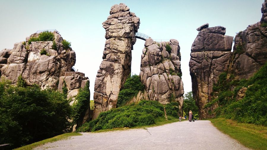 Rear view of man walking on rock formation