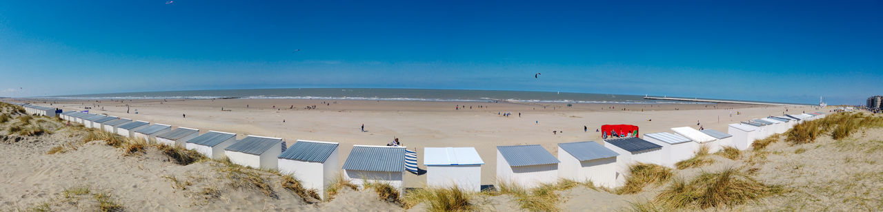 Panoramic view from a dune on the beach of nieuwpoort with strand cabins on a sunny springday
