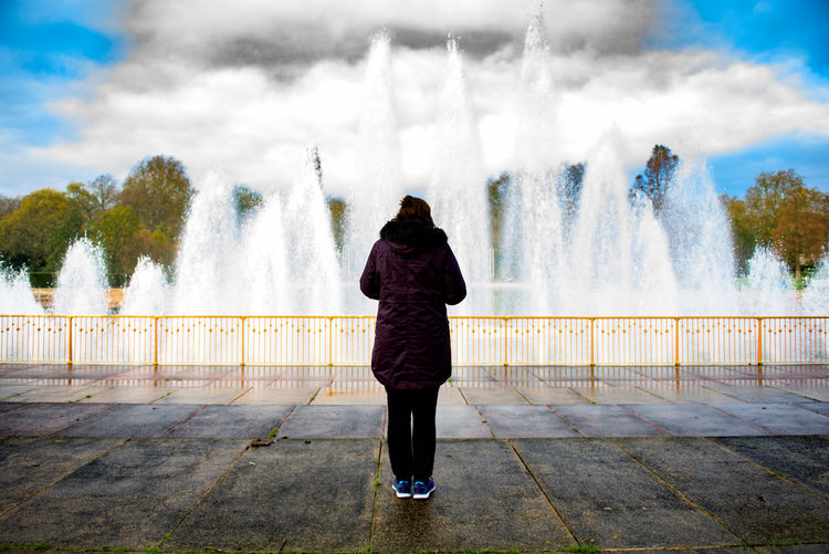 Woman standing by railing