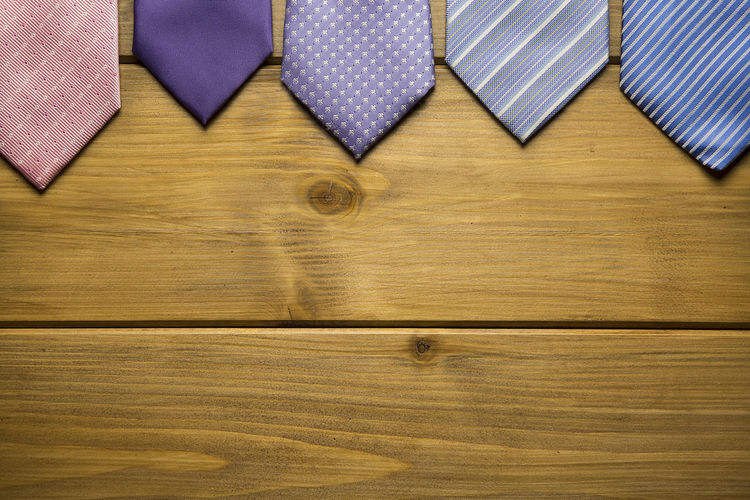 High angle view of neckties on wooden table