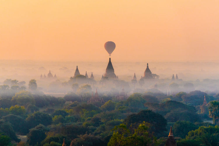 Hot air balloons against sky during sunset
