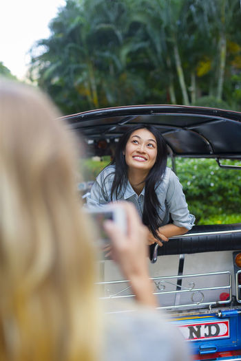 Young woman in rickshaw, bangkok, thailand