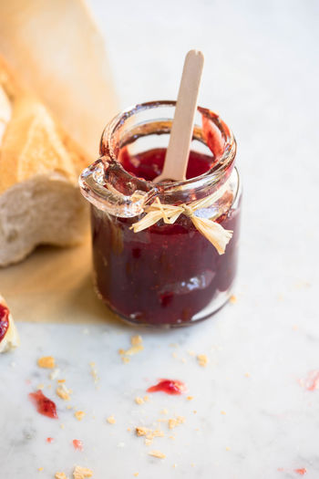 High angle view of strawberry jam jar on table