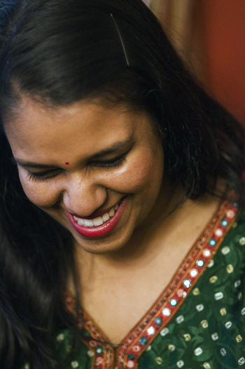 Close-up of smiling woman wearing salwar kameez looking down