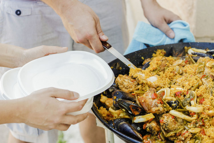 Chef serving typical spanish seafood paella