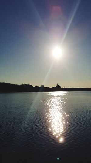 Sun shining over lake