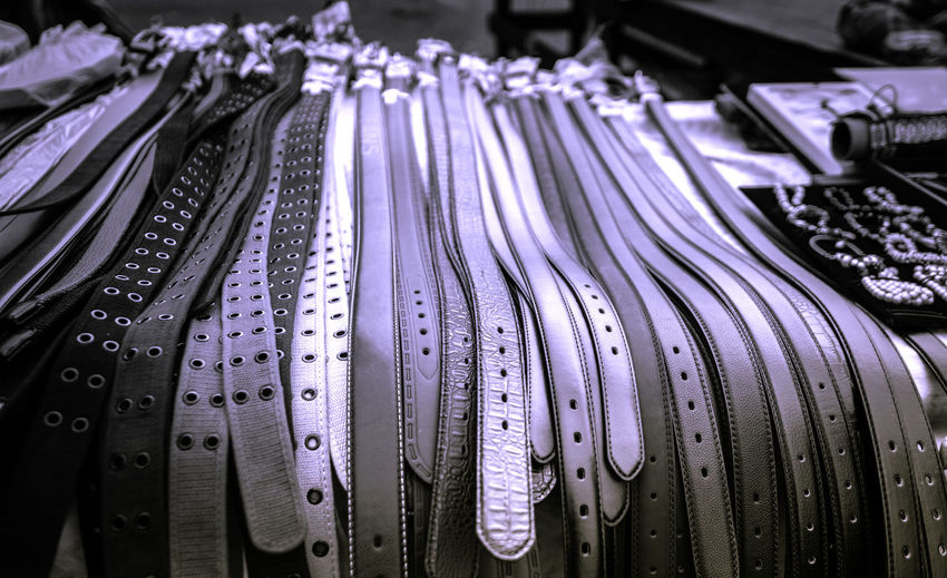 Close-up of belts for sale at market stall