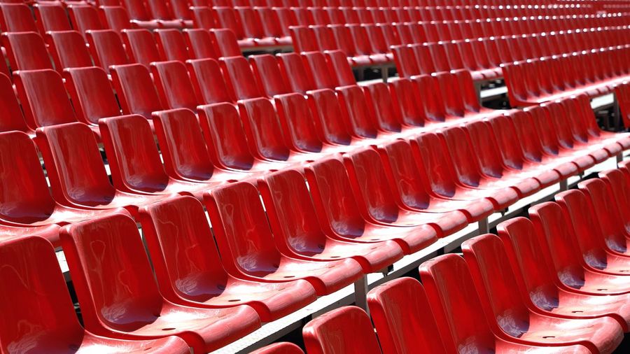 Full-frame shot of red seats on the street, red stands of the stadium