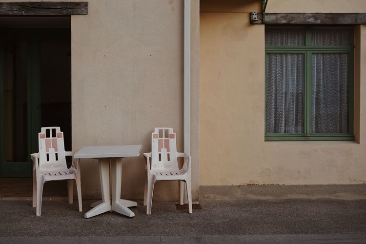 Empty chairs and table outside building