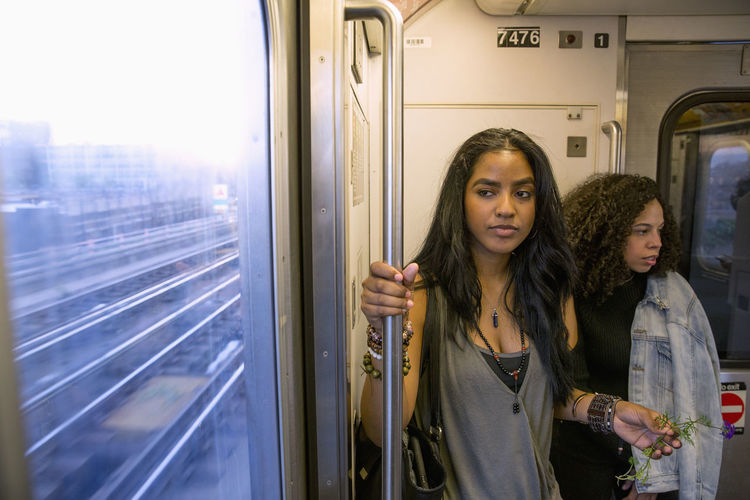 Portrait of woman standing in train