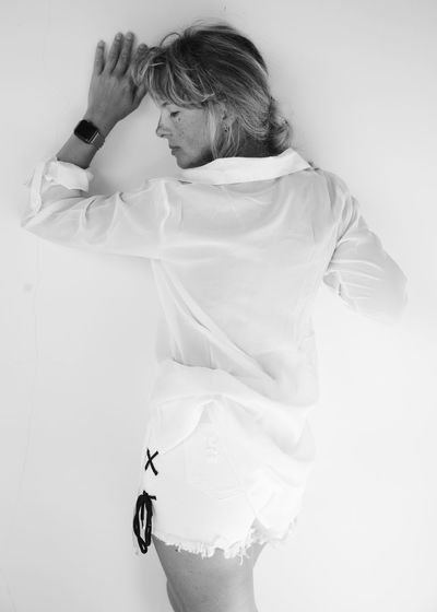 Woman wearing mask against white background