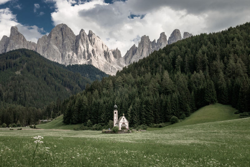 Scenic view of chapel in ranui, santa maddalena, in front of odles group mountains against sky 