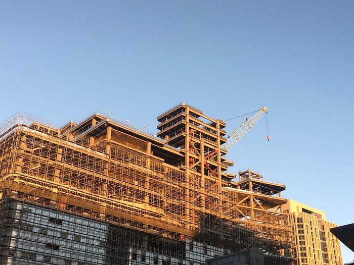 Low angle view of under construction building against clear blue sky