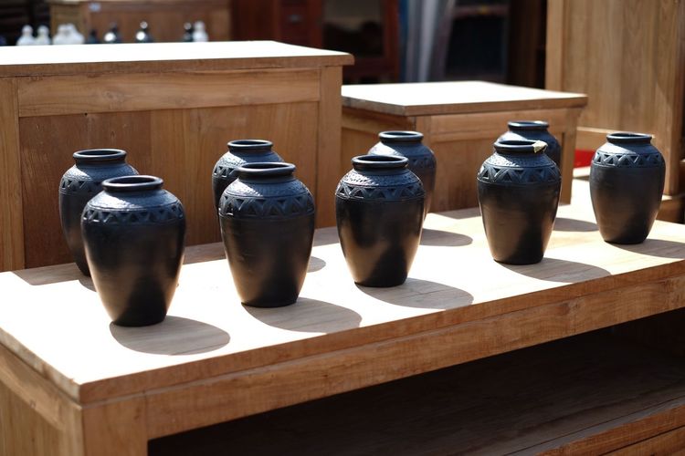 Decorative urns on wooden table for sale