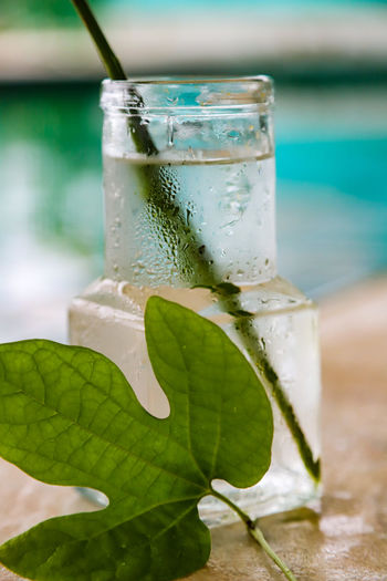 Close-up of water in glass at swimming pool