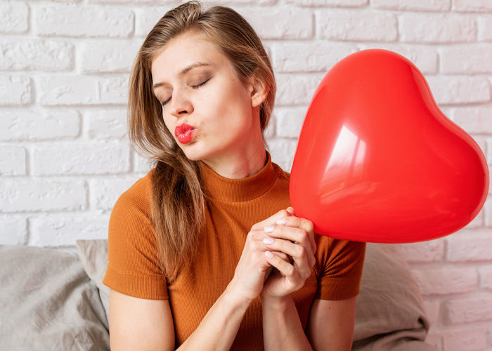 Close-up of woman holding heart shape balloon