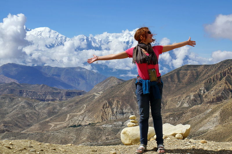 Rear view of woman standing on mountain