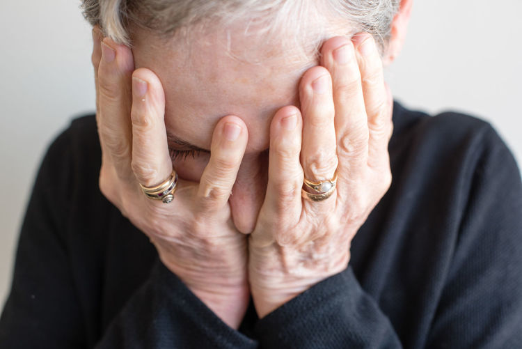 Midsection of woman covering eyes