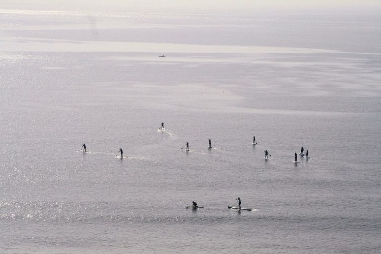 People paddling in sea