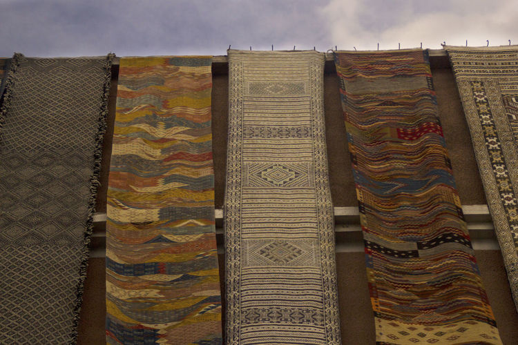 Low angle view of clothes drying on building against sky