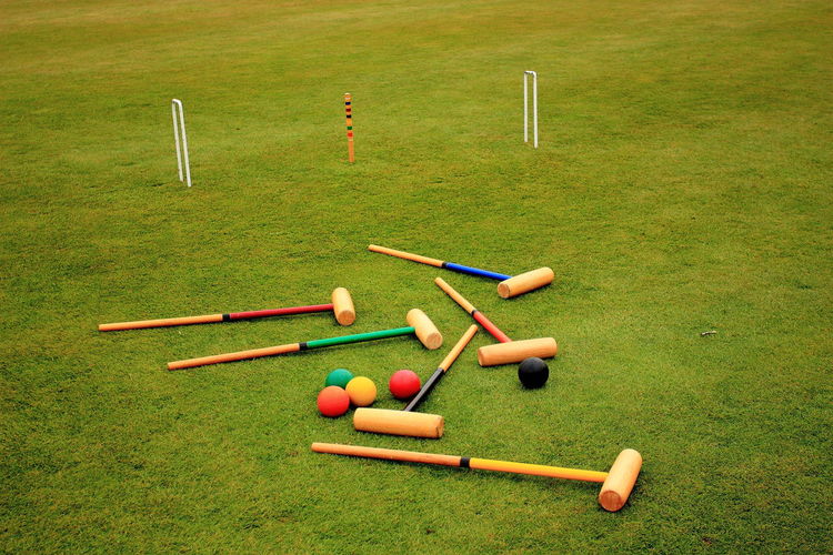 Croquet mallets and balls on field