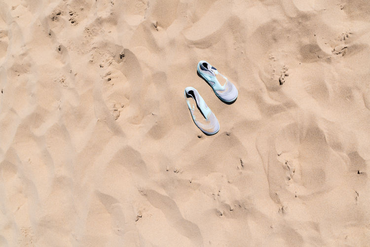 High angle view of shoes on sand