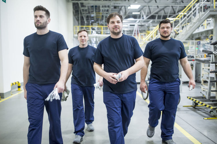Colleagues having a break and walking in a modern factory