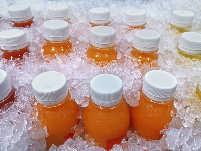 Bottles of fresh fruit juices in the ice bucket, which are orange juice, passion fruit juice