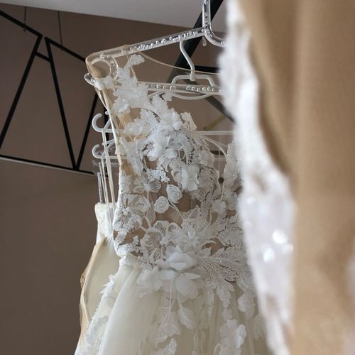 Wedding dresses hanging on rack in store