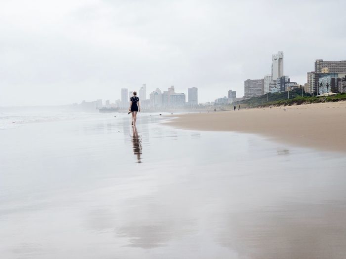 Durban south africa full length of woman on beach against sky in city