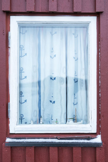 Closed window of red house