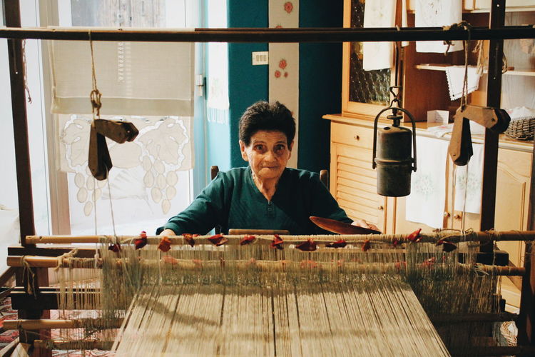Portrait of woman working on loom