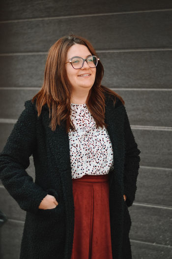 Portrait of smiling young woman standing outdoors