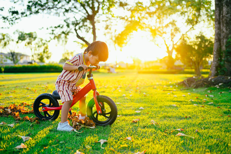 Boy riding bicycle on field