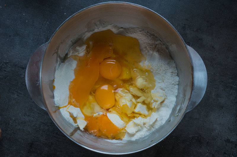 Directly above shot of butter and flour with eggs in bowl