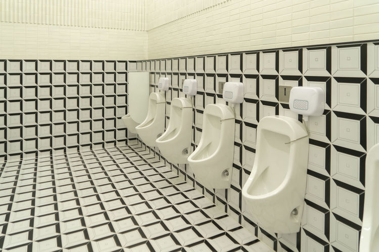 View of urinal in public restroom