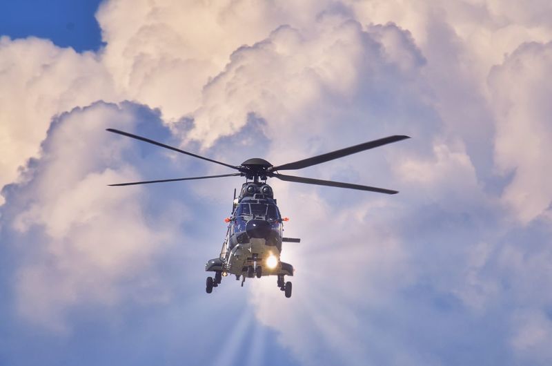 Low angle view of helicopter against sky
