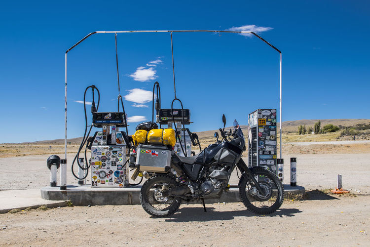 Adventure motorcycle parked at petrol station in remote area