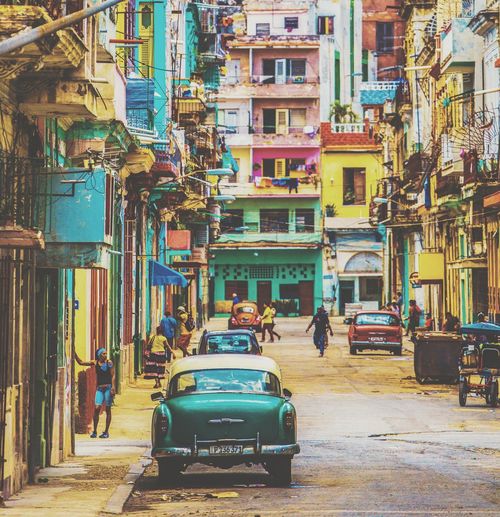 Cars on street by buildings in city