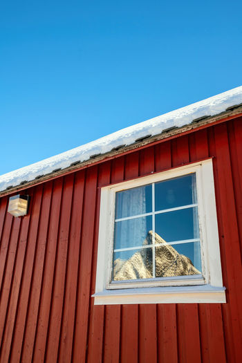Low angle view of building against clear blue sky