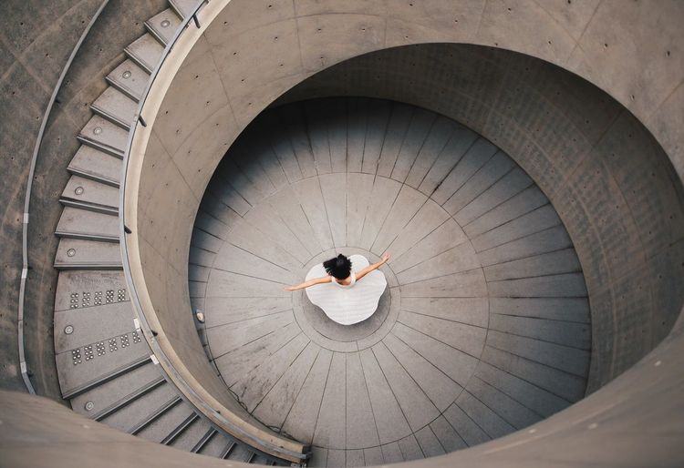 High angle view of woman and spiral staircase