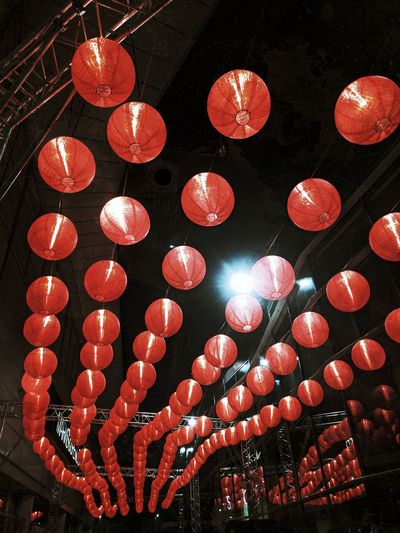 Close-up of illuminated lanterns hanging against sky