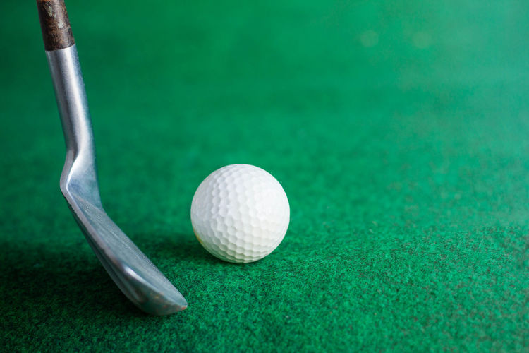 Close-up of golf ball and club