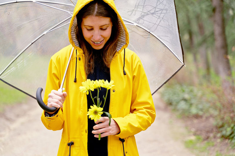 Portrait of young woman holding umbrella