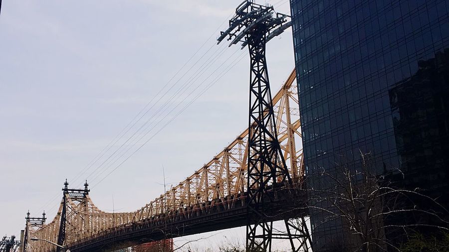 Low angle view of queensboro bridge against cloudy sky
